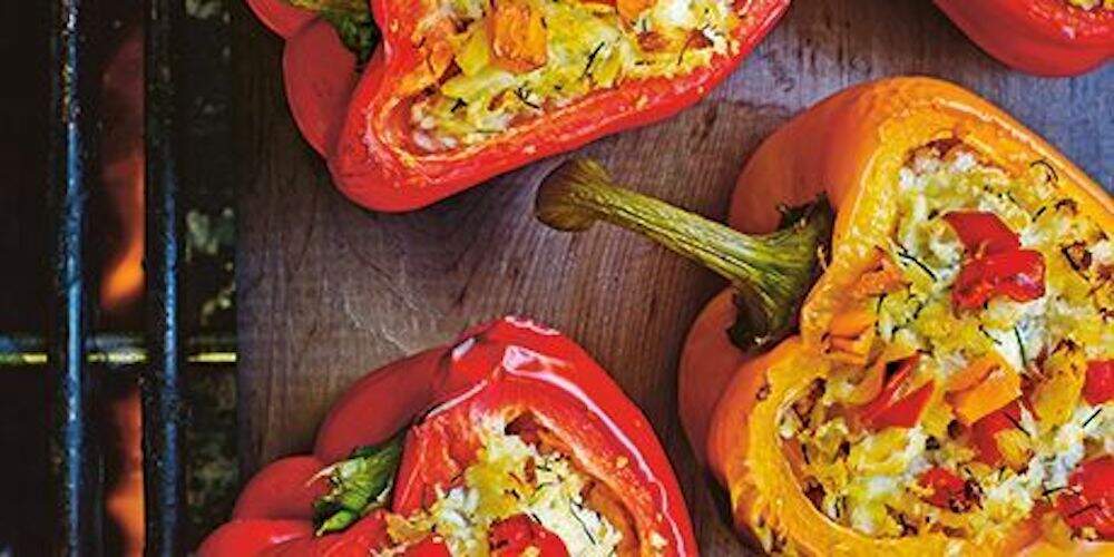 A close up of two stuffed peppers on a table
