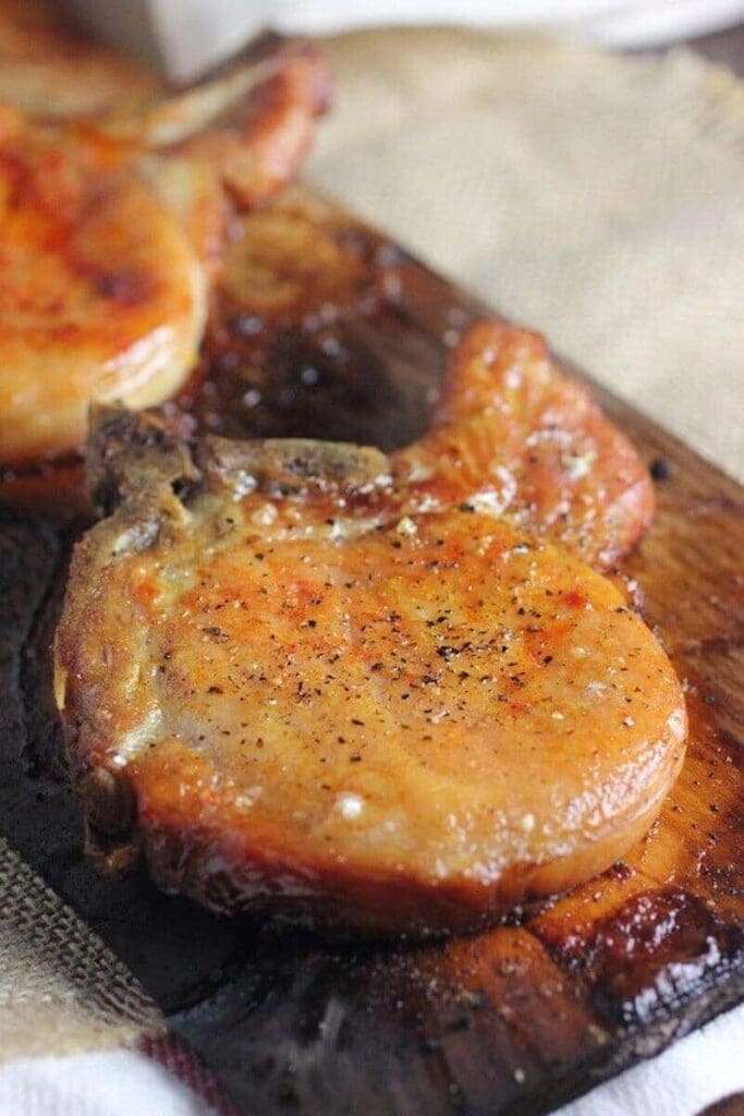 A close up of some meat on top of a wooden board