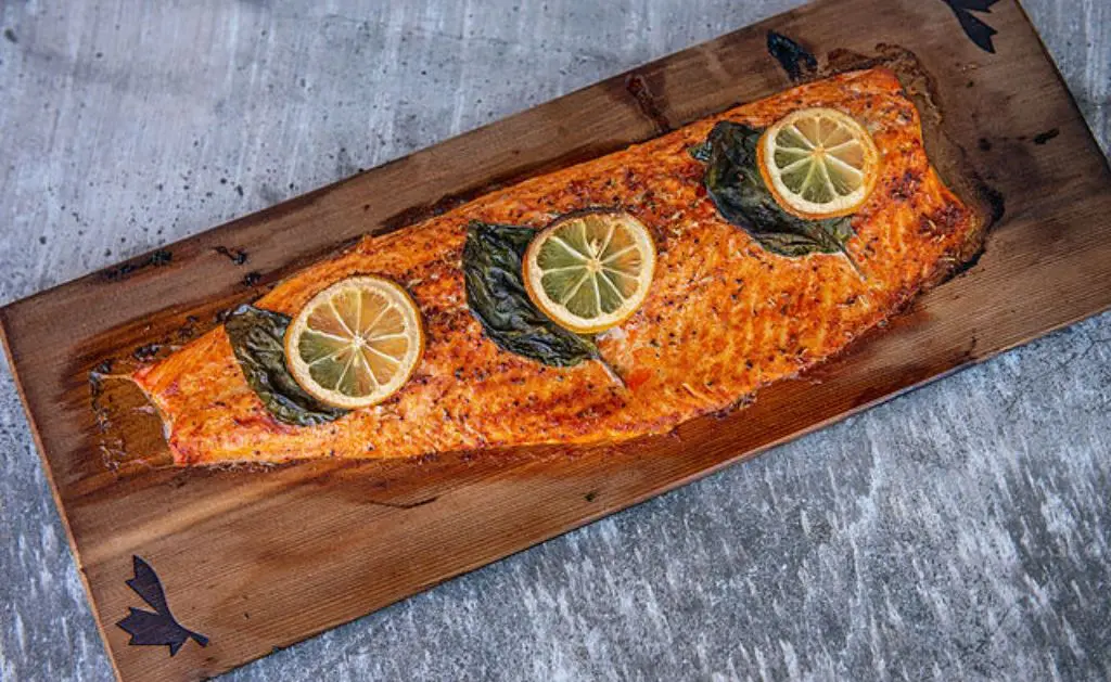 A wooden board with fish on it