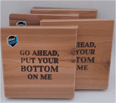 A group of wooden coasters with the words " go ahead, put your bottom on me ".